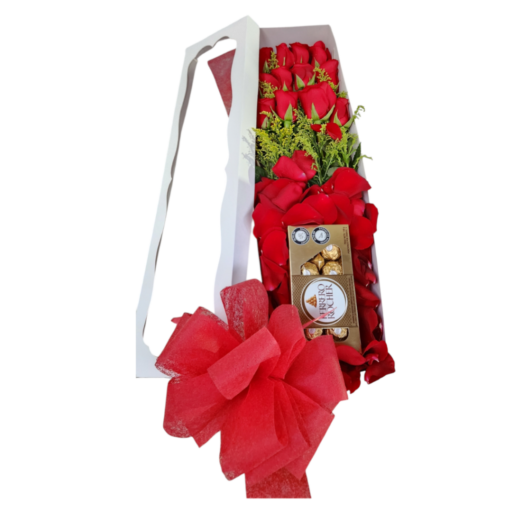 Caja blanca con 12 rosas rojas, follaje, pétalos, chocolates Ferrero y moño, un detalle elegante y romántico.