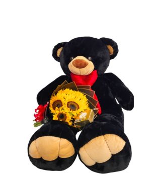Oso de peluche negro con girasoles y chocolates.